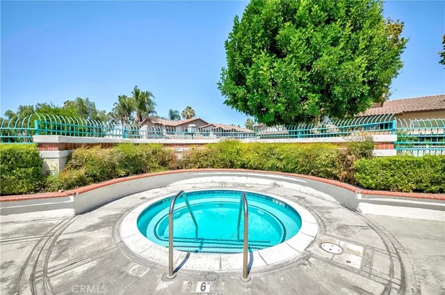 a view of a swimming pool with a yard and plants