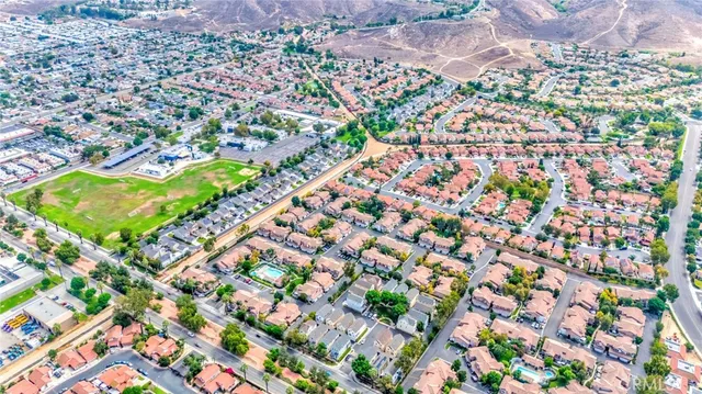 an aerial view of a house with a yard and garden