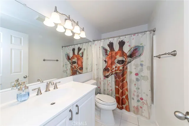 a bathroom with a sink vanity mirror and toilet