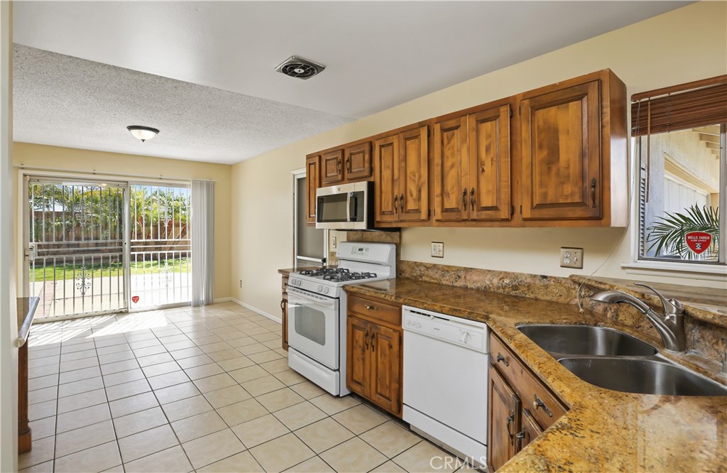 15902 King Circle Westminster, CA 92683 - Photo 11 of 43 a kitchen with a stove a sink and a microwave