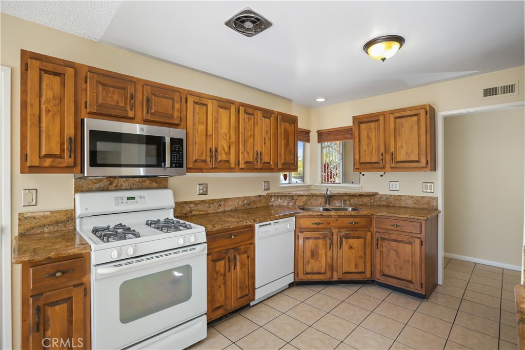 15902 King Circle Westminster, CA 92683 - Photo 16 of 43 a kitchen that has a sink and a stove in it