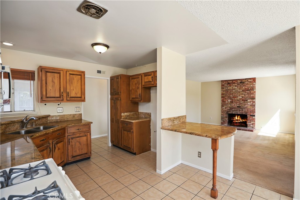 15902 King Circle Westminster, CA 92683 - Photo 17 of 43 a kitchen with stainless steel appliances granite countertop a refrigerator and a stove top oven