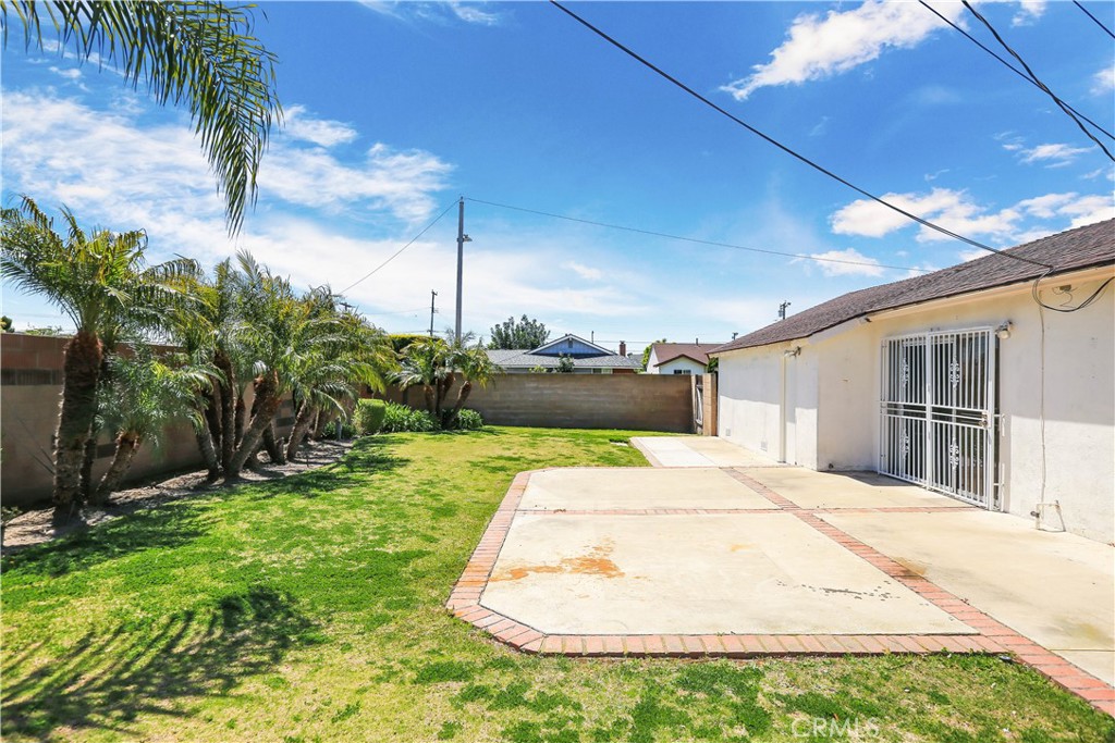 15902 King Circle Westminster, CA 92683 - Photo 29 of 43 a white house with a yard and potted plants