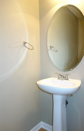 a bathroom with a sink a mirror and vanity