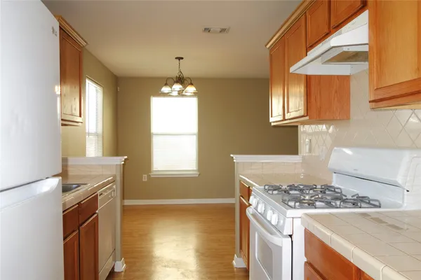 a kitchen with a stove and a window