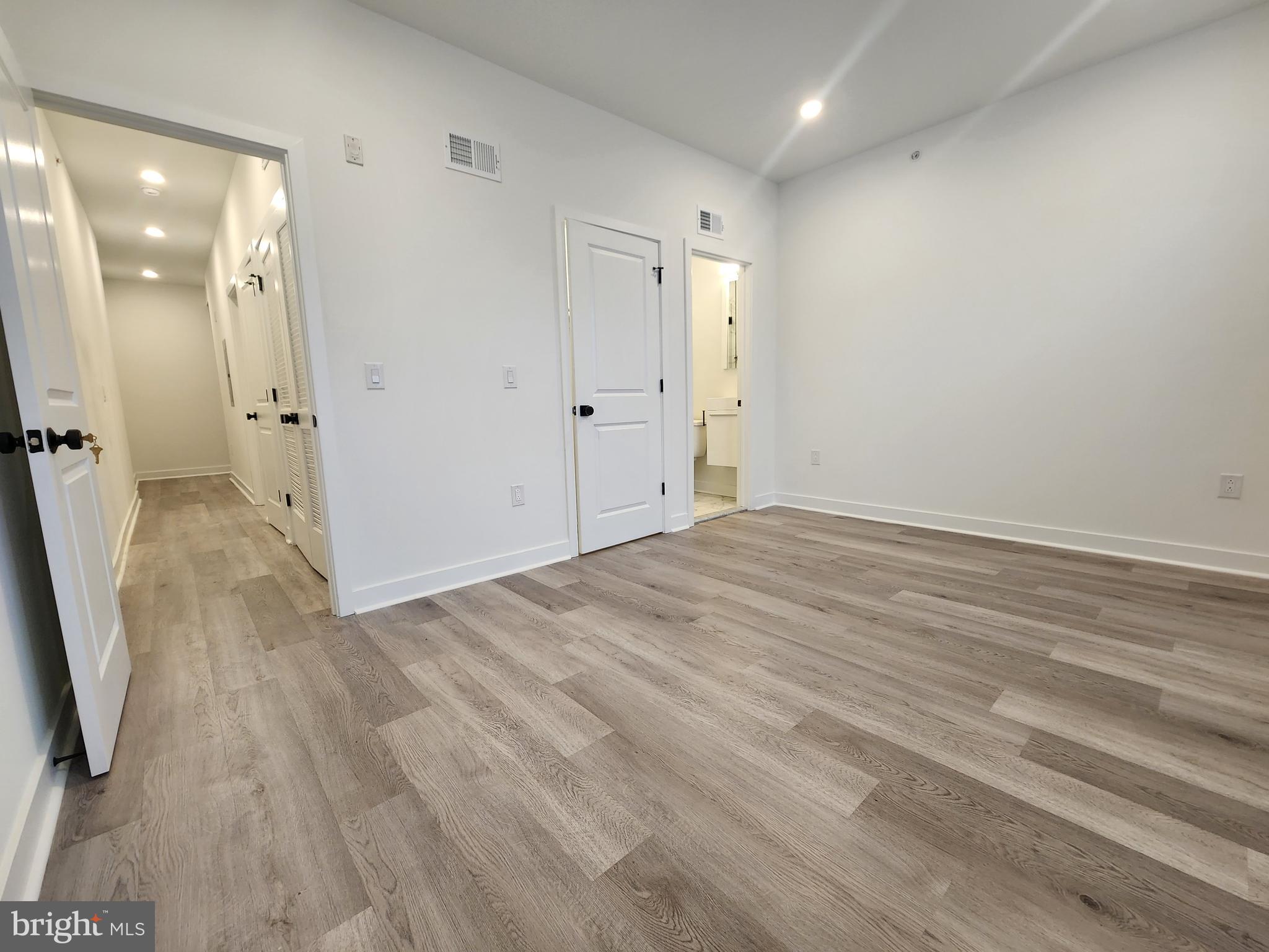 1838 North 17th Street, Unit 3 Philadelphia, PA 19121 - Photo 11 of 14 a view of a room with wooden floor and mirror