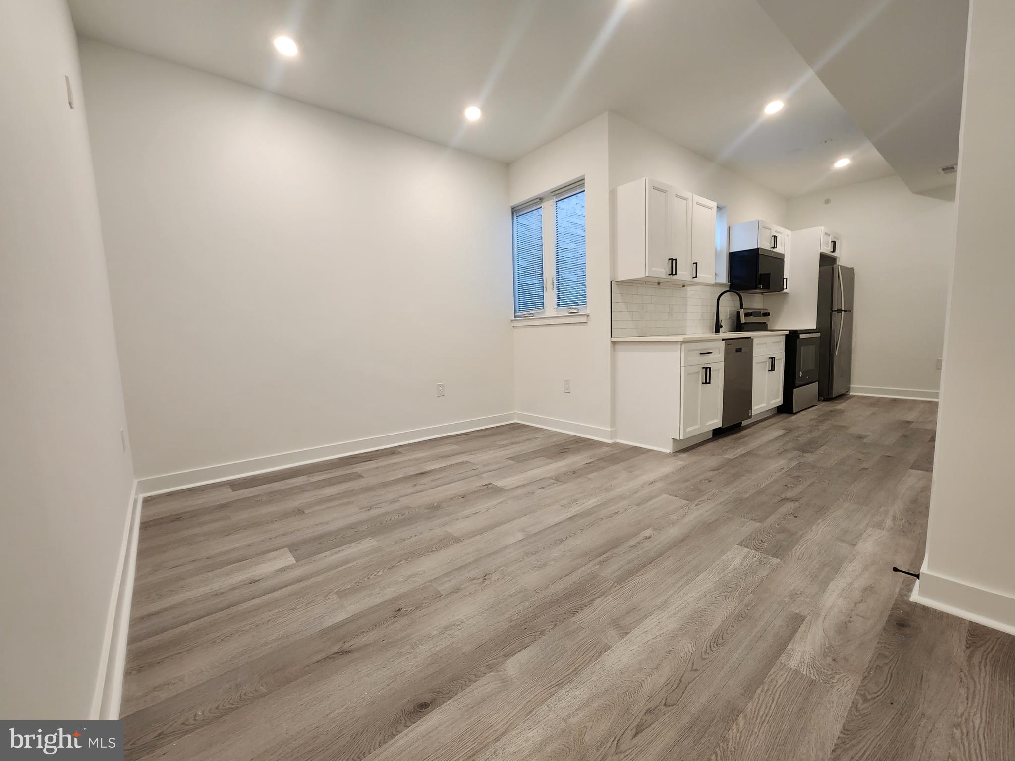 1838 North 17th Street, Unit 3 Philadelphia, PA 19121 - Photo 3 of 14 a view of kitchen with stainless steel appliances refrigerator and microwave