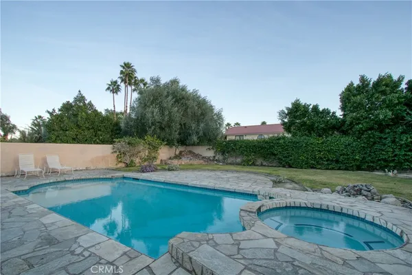 a view of a swimming pool with a yard