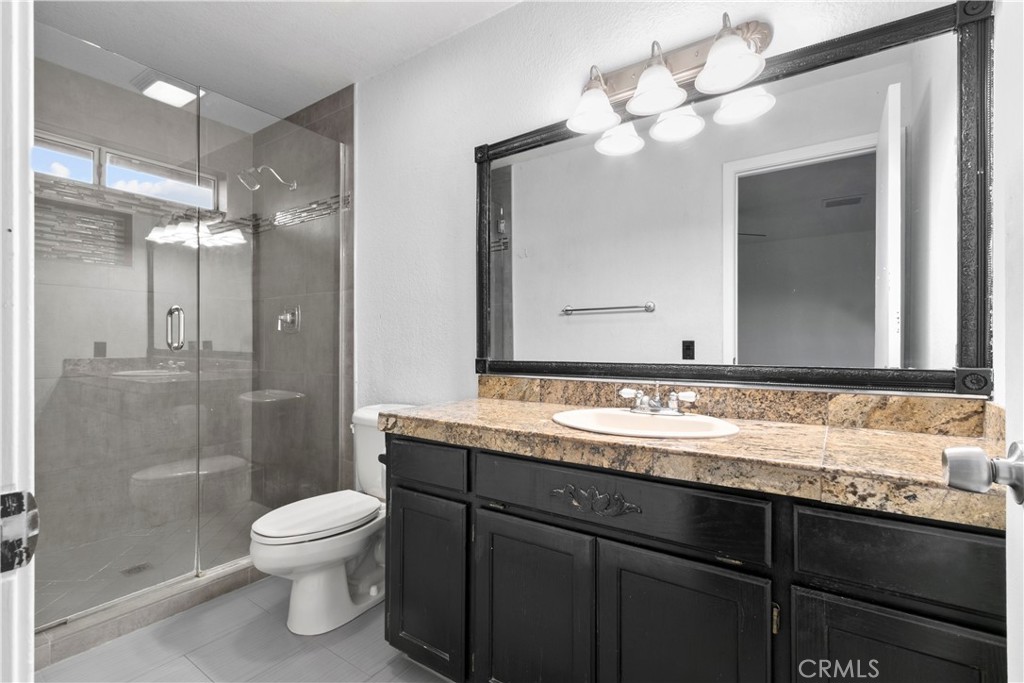 68295 Marina Road Cathedral City, CA 92234 - Photo 13 of 39 a bathroom with a sink a toilet and a mirror