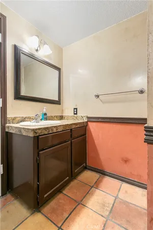 a bathroom with a sink a mirror and vanity