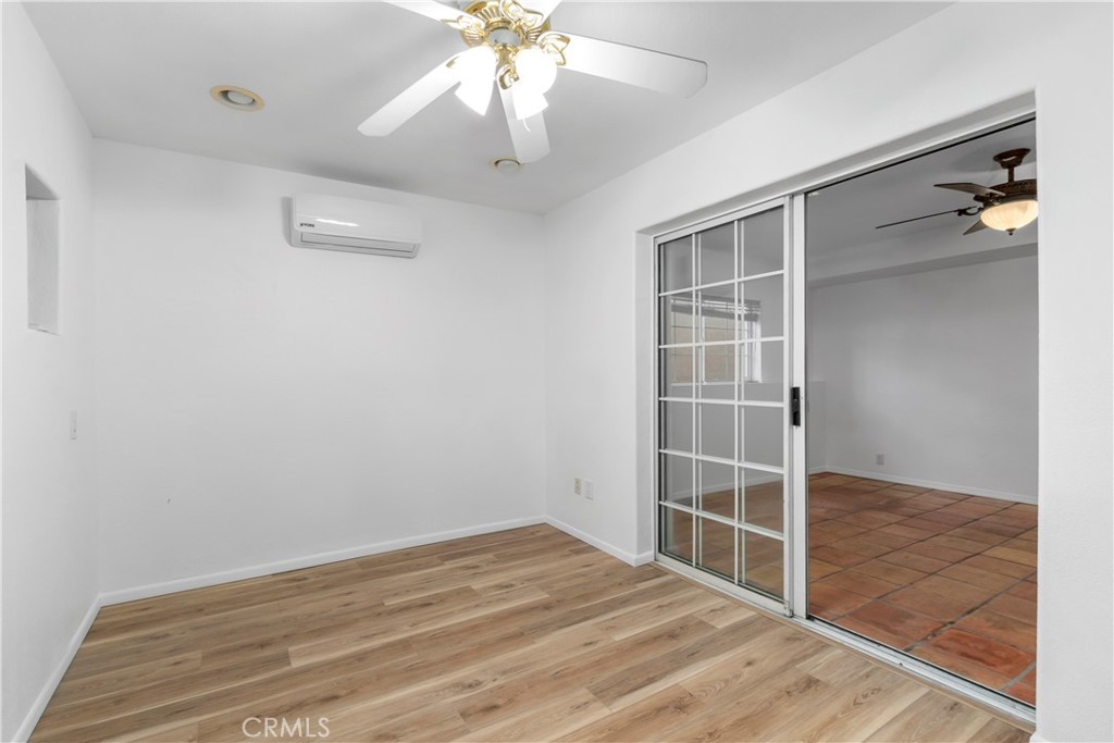 68295 Marina Road Cathedral City, CA 92234 - Photo 22 of 39 an empty room with wooden floor closet and windows
