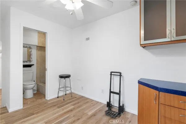 a view of a bedroom with wooden floor and windows