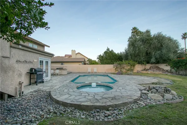 a view of a house with a yard and sitting area