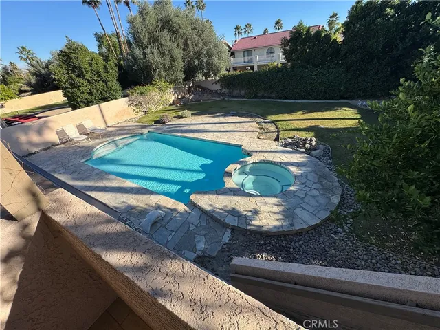 a view of a swimming pool with a yard