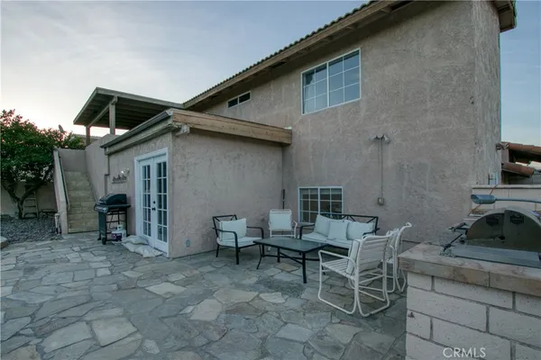 a backyard of a house with table and chairs