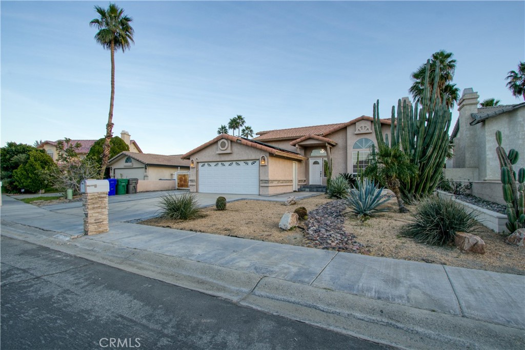 68295 Marina Road Cathedral City, CA 92234 - Photo 39 of 39 a front view of a house with a yard and garage