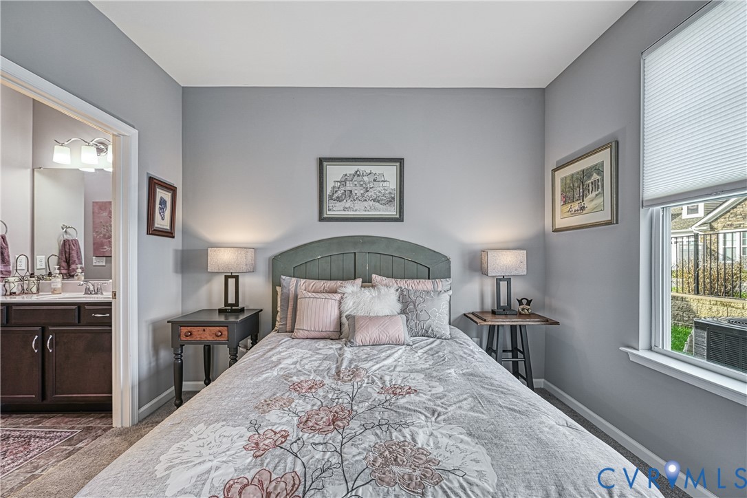 1009 Woodlet Meadow Lane Richmond, VA 23236 - Photo 30 of 44 a bedroom with a large bed and a window