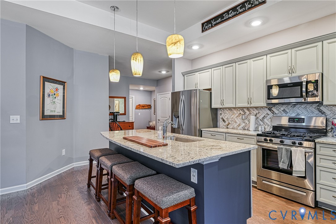 1009 Woodlet Meadow Lane Richmond, VA 23236 - Photo 7 of 44 a kitchen with a stove a refrigerator and a dining table
