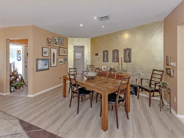a view of a dining room with furniture and wooden floor