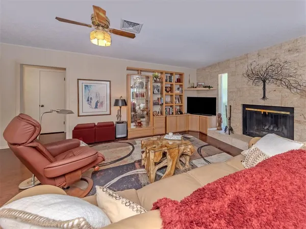 a living room with furniture a flat screen tv and a fireplace