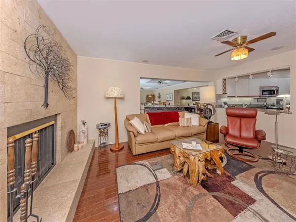 a living room with furniture a fireplace and a flat screen tv