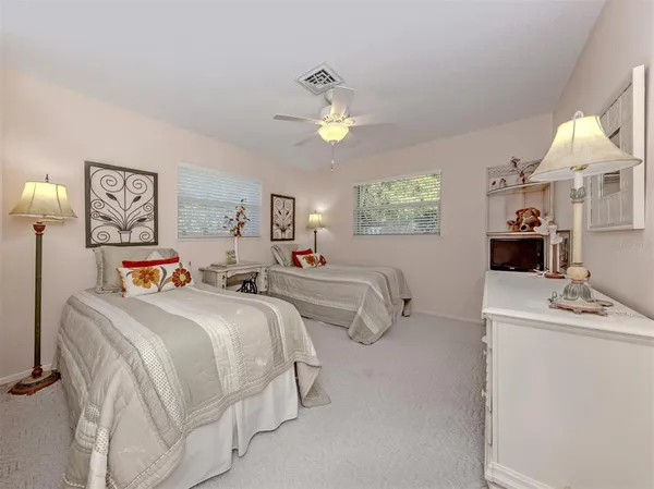 a bedroom with double bed and a chandelier