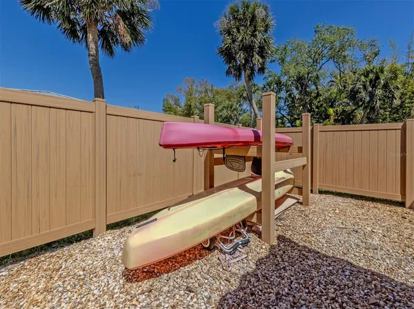 a view of a backyard with a table and chair under an umbrella