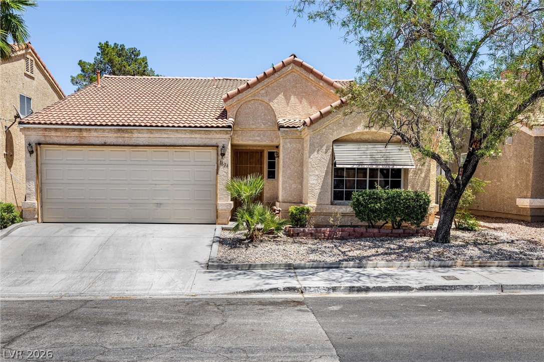 1624 Palmae Way Las Vegas, NV 89128 - Photo 1 of 18 This one-story residence showcases a garage and an inviting entrance, framed by mature landscaping.