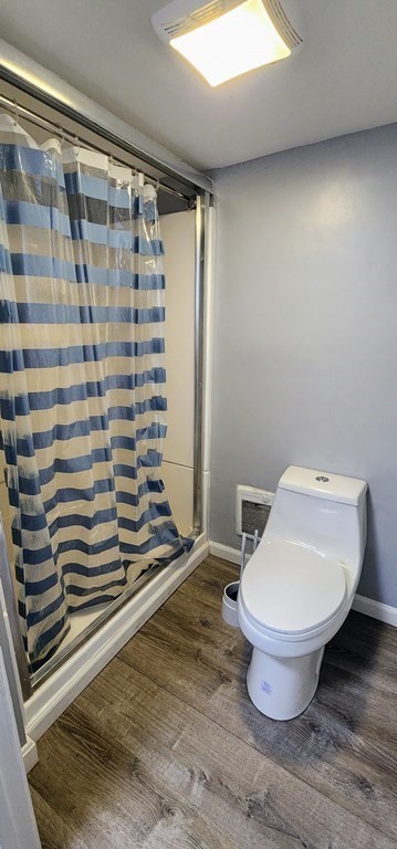 212 Vernon Street Worcester, MA 01607 - Photo 15 of 35 a bathroom with a toilet and a shower