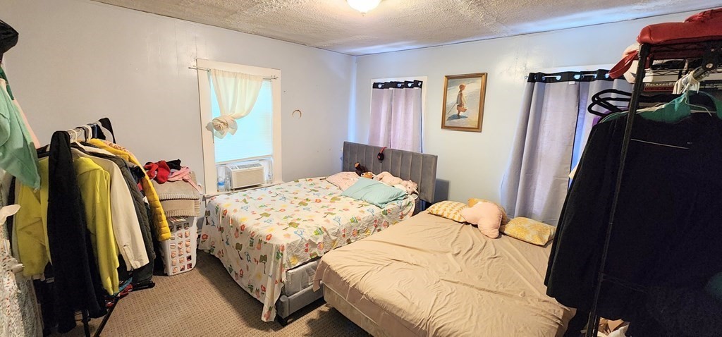 212 Vernon Street Worcester, MA 01607 - Photo 27 of 35 a bedroom with a bed and a walk in closet