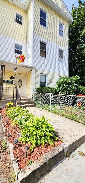 212 Vernon Street Worcester, MA 01607 - Photo 3 of 35 a front view of a house with a yard and a glass top table