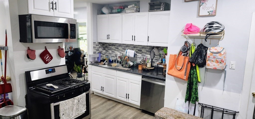 212 Vernon Street Worcester, MA 01607 - Photo 32 of 35 a kitchen with stainless steel appliances white cabinets and a stove