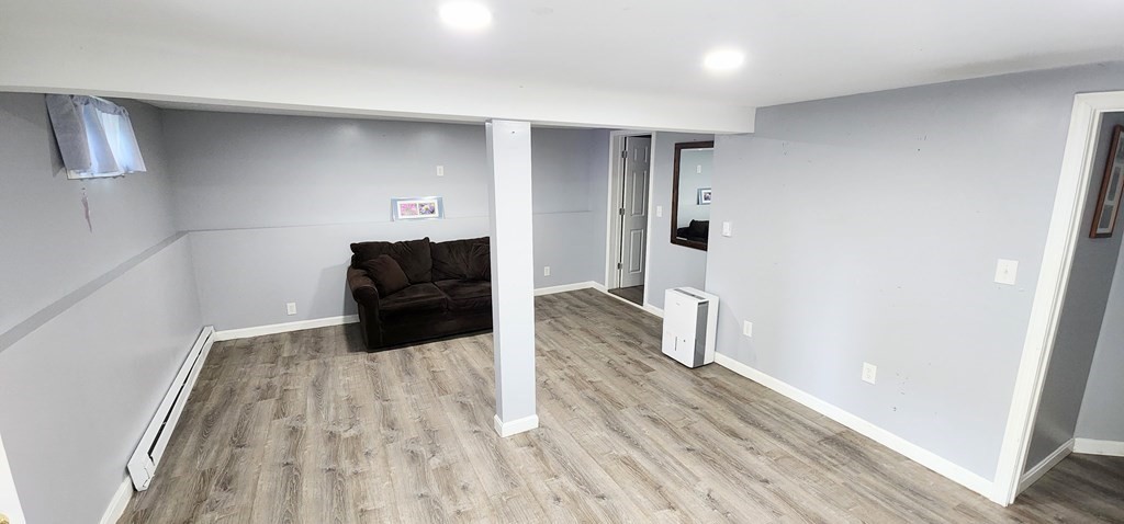 212 Vernon Street Worcester, MA 01607 - Photo 10 of 35 a living room with a couch and wooden floor