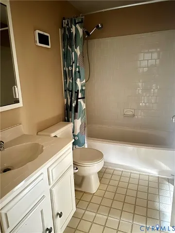 a view of a house with a small yard and a large tree