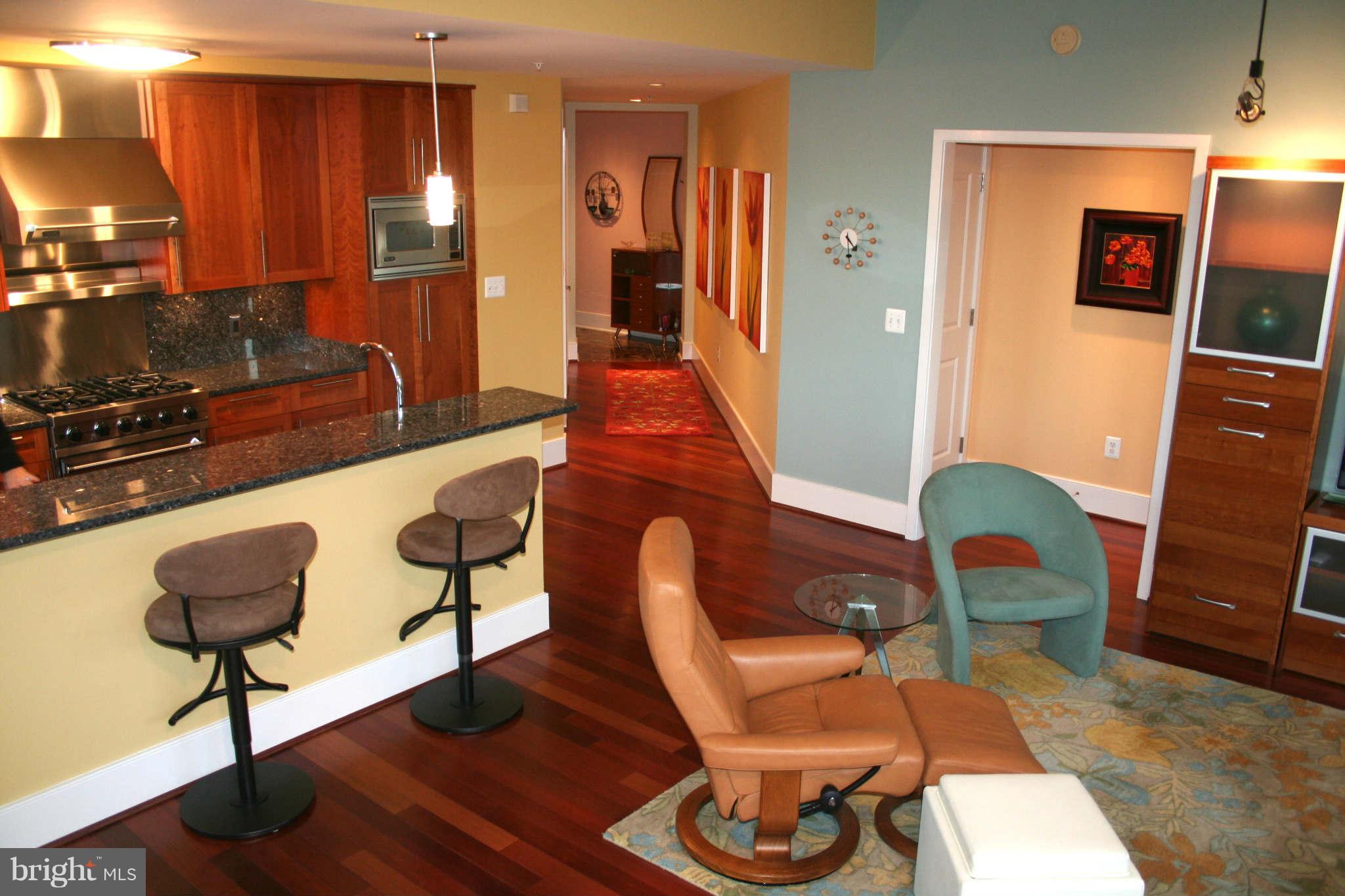 4301 Military Road Northwest, Unit 514 Washington, DC 20015 - Photo 11 of 29 a living room with furniture and wooden floor