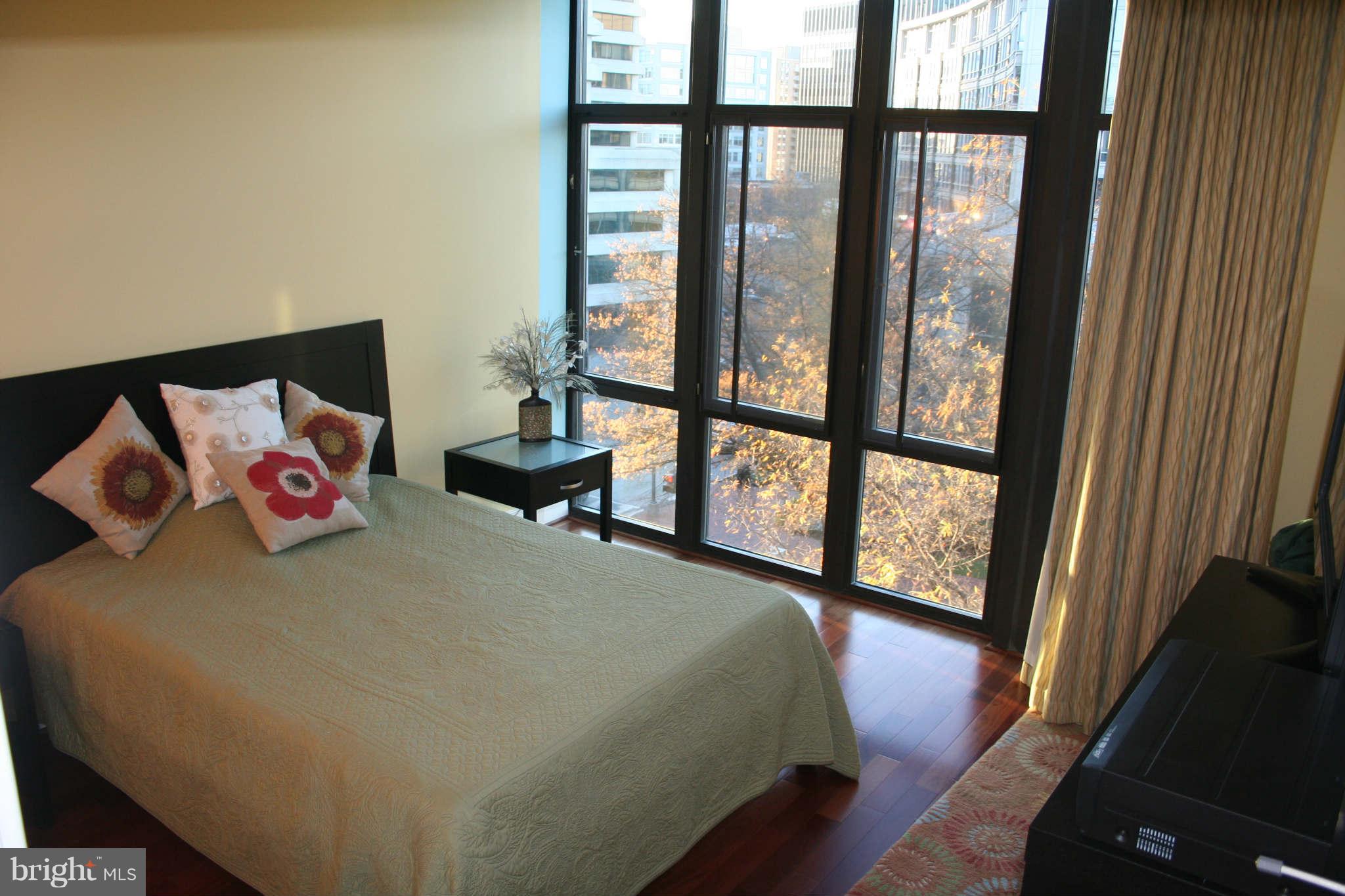 4301 Military Road Northwest, Unit 514 Washington, DC 20015 - Photo 12 of 29 a bedroom with a bed and a large window