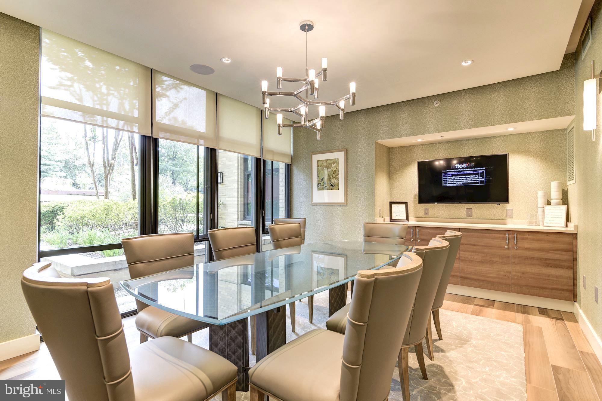 4301 Military Road Northwest, Unit 514 Washington, DC 20015 - Photo 17 of 29 a dining room with furniture a chandelier and wooden floor