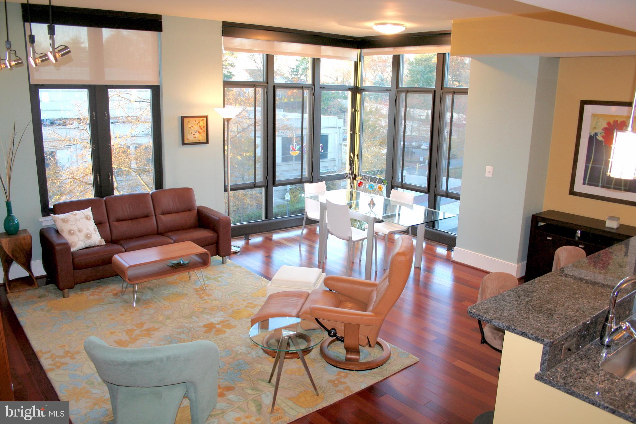 4301 Military Road Northwest, Unit 514 Washington, DC 20015 - Photo 3 of 29 a living room with furniture and floor to ceiling windows