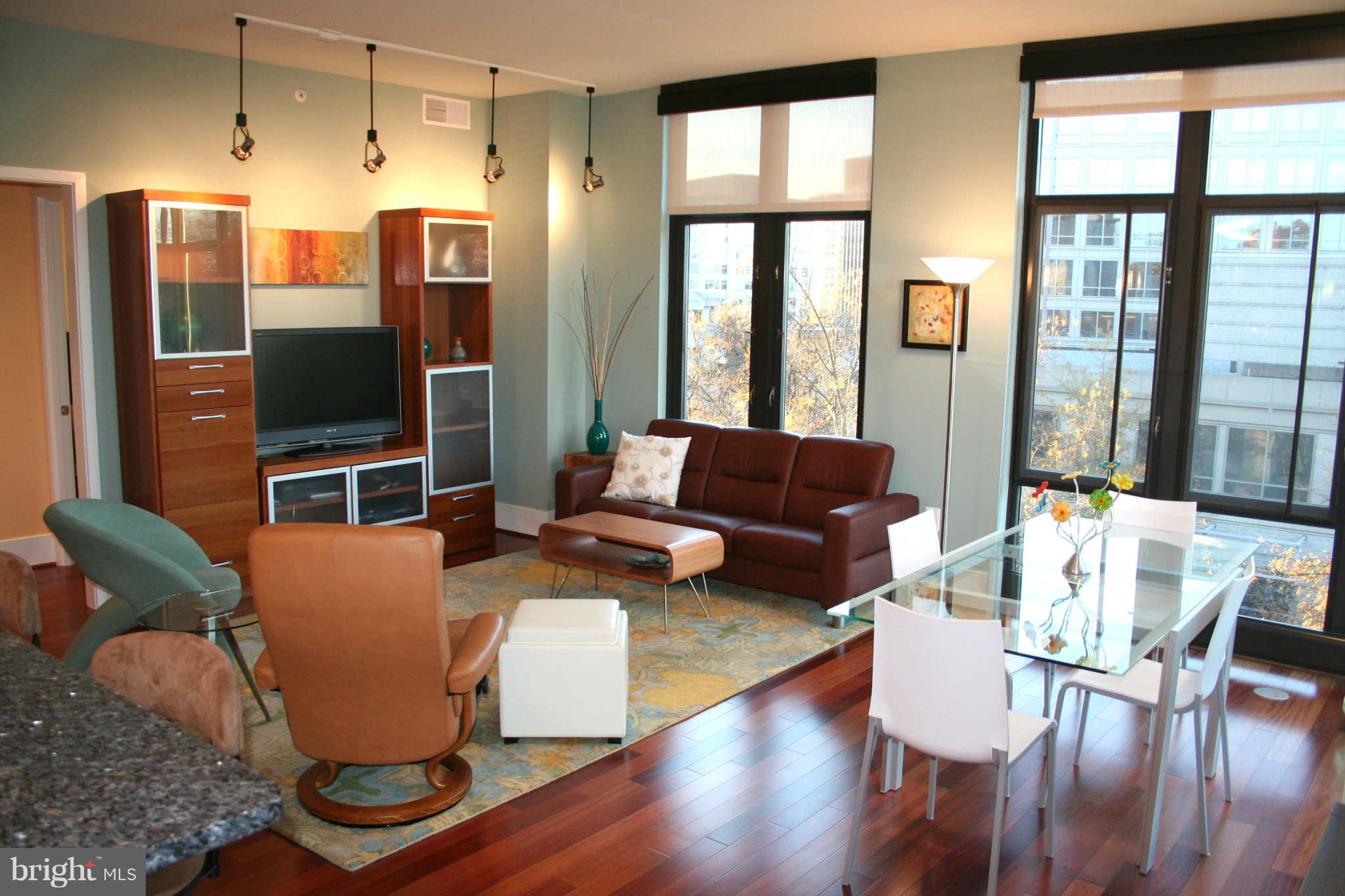 4301 Military Road Northwest, Unit 514 Washington, DC 20015 - Photo 5 of 29 a living room with furniture a flat screen tv and a large window