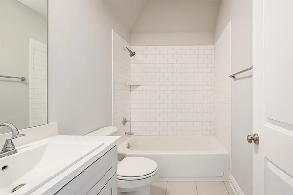 a bathroom with a toilet a sink and bathtub