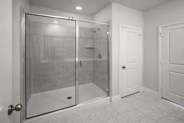 a bathroom that has a glass shower door