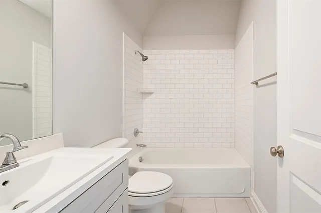 a bathroom with a toilet a sink and bathtub
