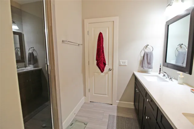 a bathroom with a double vanity sink and a mirror