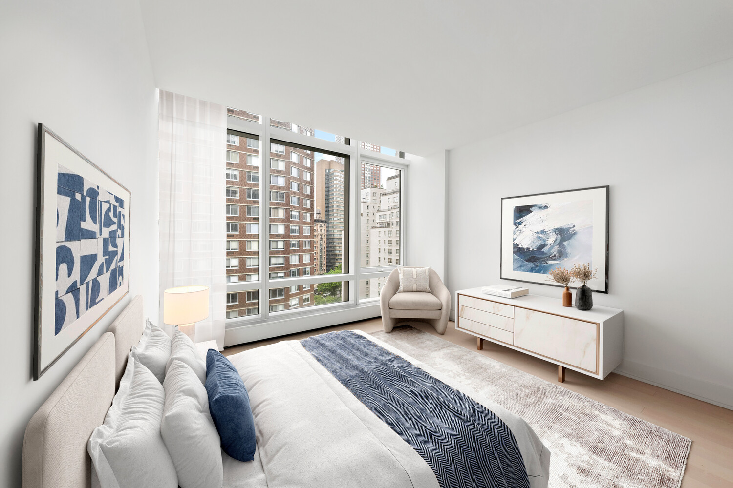 200 Amsterdam Avenue, Unit 11C Manhattan, NY 10023 - Photo 5 of 7 a spacious bedroom with a large bed and a couch