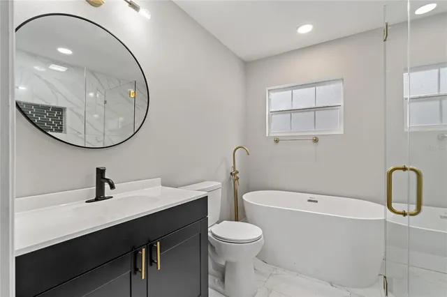 a bathroom with a sink a toilet and mirror