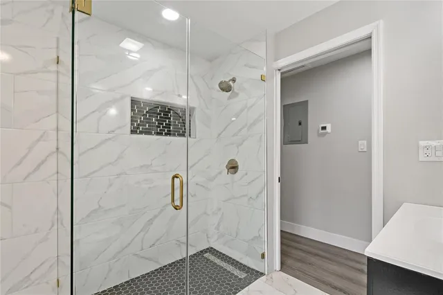 a bathroom with a shower and a sink