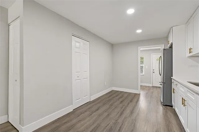 a view of a hallway with wooden floor