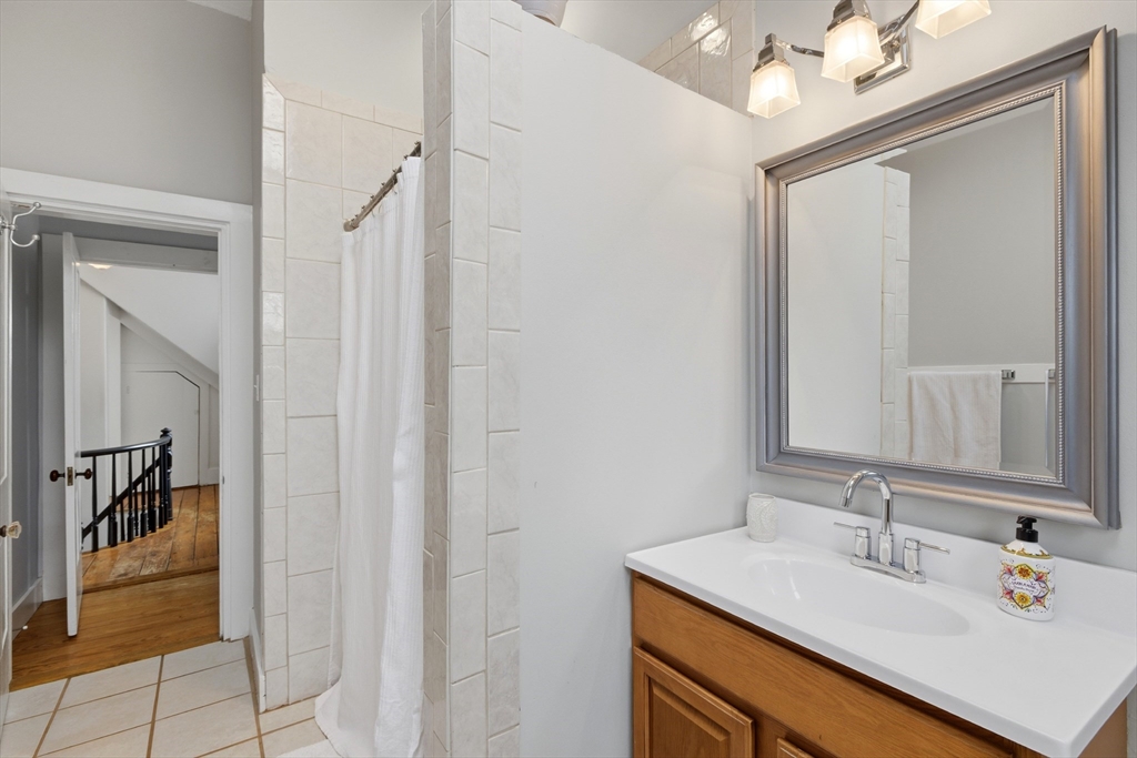 8 Linden Street Marblehead, MA 01945 - Photo 26 of 41 a bathroom with a sink vanity and a mirror