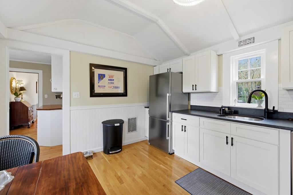 8 Linden Street Marblehead, MA 01945 - Photo 8 of 41 a kitchen with stainless steel appliances granite countertop a sink dishwasher a refrigerator and white cabinets with wooden floor