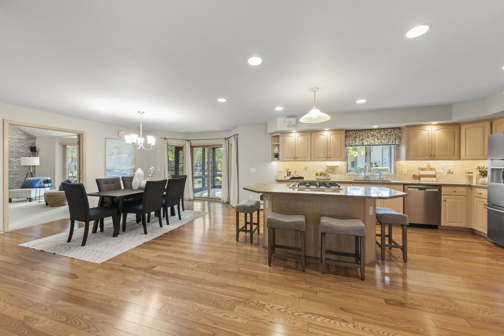 1048 Parkside Road Naperville, IL 60540 - Photo 3 of 35 a view of a dining area with furniture kitchen appliances and wooden floor